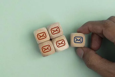 Hand hold wooden cube with a row of email icons. the concept of email has n.. Photos