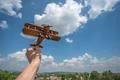 The hand hold a wooden plane above the land Photo
