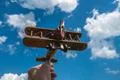 The hand hold a wooden plane on the background of the cloud Photo