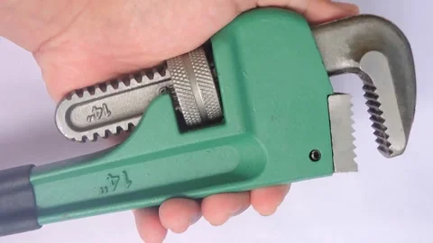 Hand Holding a 14-Inch Pipe Wrench for Plumbing Work Stock Footage 304257658