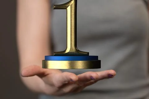 Hand holding a 3D render of a first place trophy 스톡 사진
