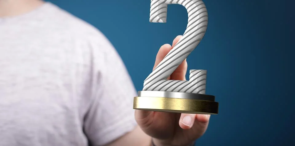 Hand holding a 3D render of a second place trophy 스톡 사진