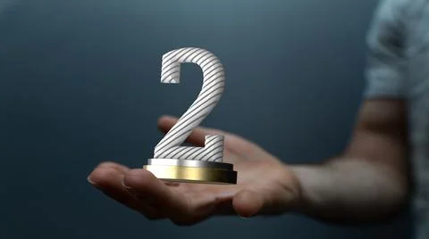 Hand holding a 3D render of a second place trophy 스톡 사진