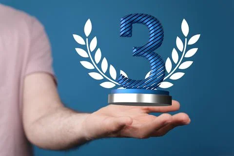 Hand holding a 3D render of a third place trophy 스톡 사진