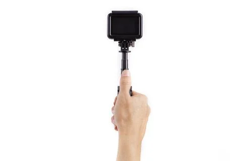 Hand holding action camera on the stabilizer isolated on white background Stock Photos