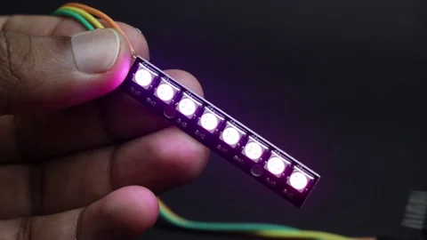 Hand holding an addressable RGB or ARGB LED strip light Stock Footage 336626582