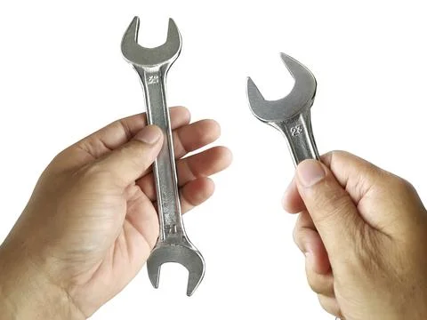 Hand holding Adjustable spanner or adjustable wrench isolated on white backgr Stock Photos