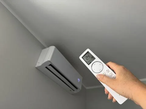 Hand holding an air conditioner remote control  Stock Photos