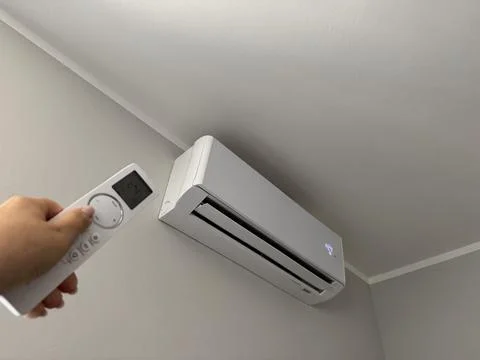 Hand holding an air conditioner remote control  Stock Photos
