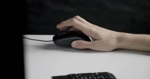 Hand holding and clicking a computer mouse 動画素材 104608023