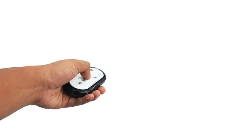Hand holding and pressing a button on a small black and white electronic re.. Stock Photos