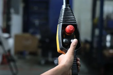 Hand holding and push button the overhead crane remote Stock Photos