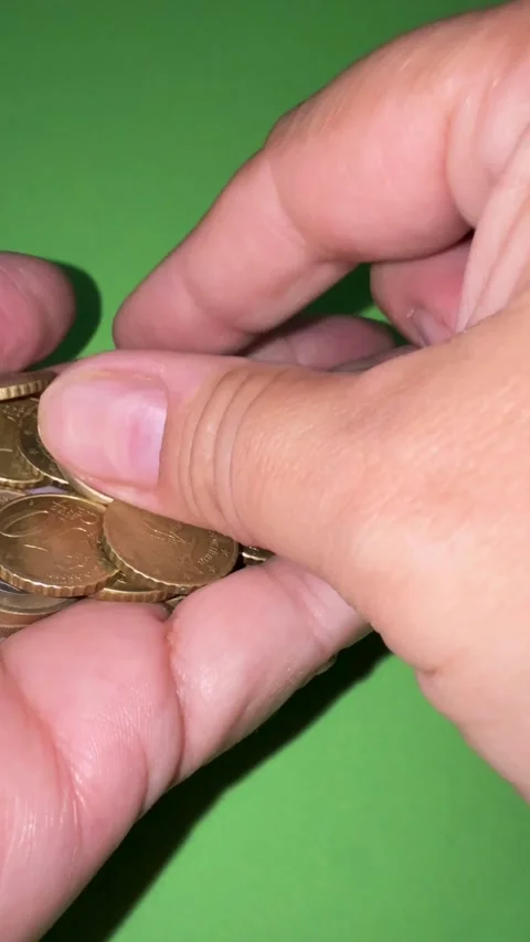 Hand holding and sorting through various euro cent coins Видео 334592660