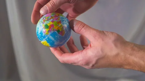 The hand is holding and throwing up the globe. The world is in your hands. Slow 스톡 동영상 98562808