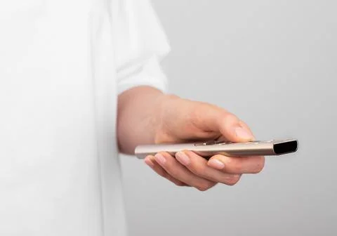 Hand holding and using remote control, closeup Stock Photos