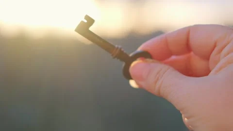 Hand holding antique key held against su... | Stock Video | Pond5