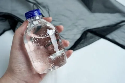 Hand holding Aqua cube bottled water Stock Photos