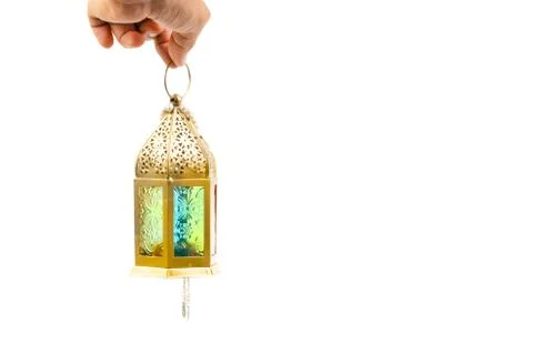 Hand holding arabic lantern isolate on white. Stock-Fotos