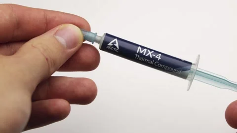 Hand Holding Arctic MX-4 Thermal Compound Syringe Stock Footage 345989533
