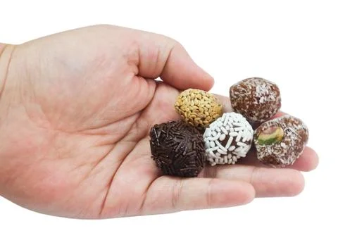Hand Holding Assorted Round Chocolate Candy Balls Stock Photos