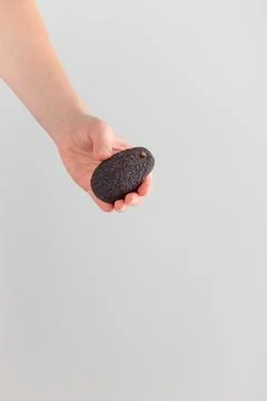Hand holding an avocado Stock Photos