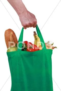 Hand holding a bag with groceries Stock Photos