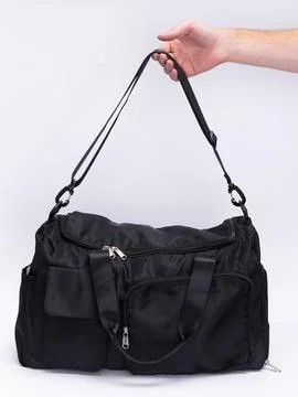 Hand holding bag by strap Stock Photos