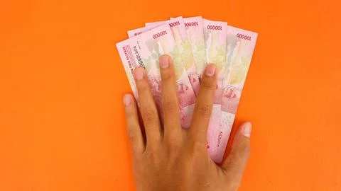 Hand holding banknotes with a total of five hundred thousand rupiah isolated  Stock Photos