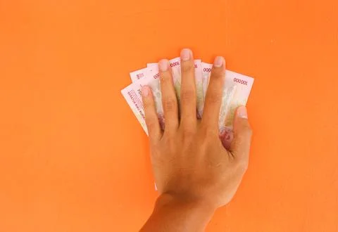 Hand holding banknotes with a total of five hundred thousand rupiah isolated  Stock Photos