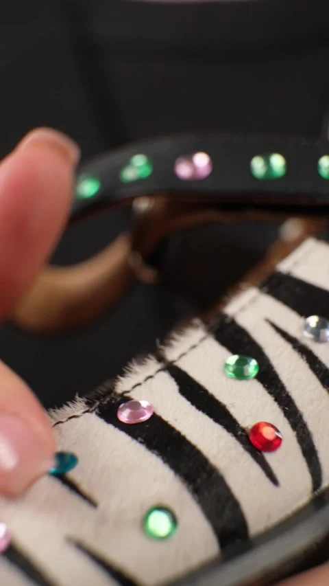 Hand Holding Beaded Zebra Pattern Shoe Video stock 303773441