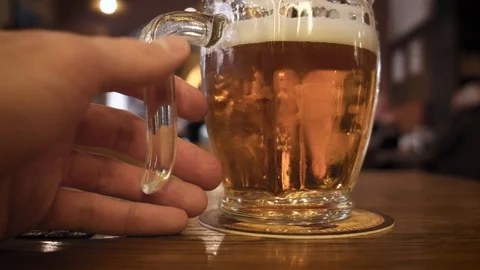 Hand holding beer Stock Footage 98215288