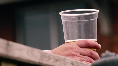 Hand holding beer in plastic beaker at festival Stock Footage 242987291