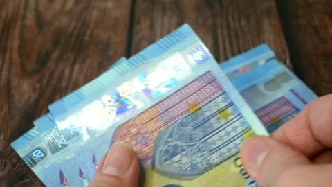 Hand holding big stack of euro money on wooden background. money cash Stock Footage 304860576