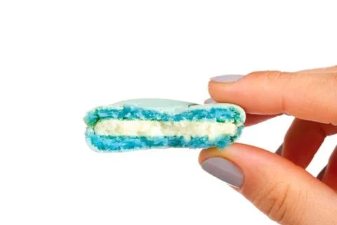 Hand Holding Bitten Macaron Stock Photos