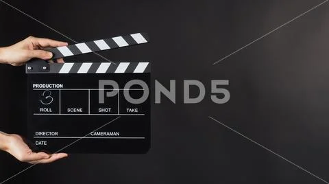 Hand is holding Black clap board or movie slate use in video production , mo Stock-Fotos