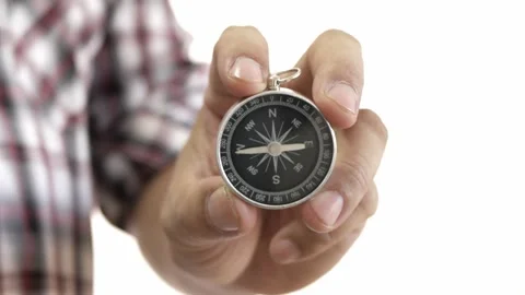 Hand holding the black compass on white background. Stock Footage 229563933
