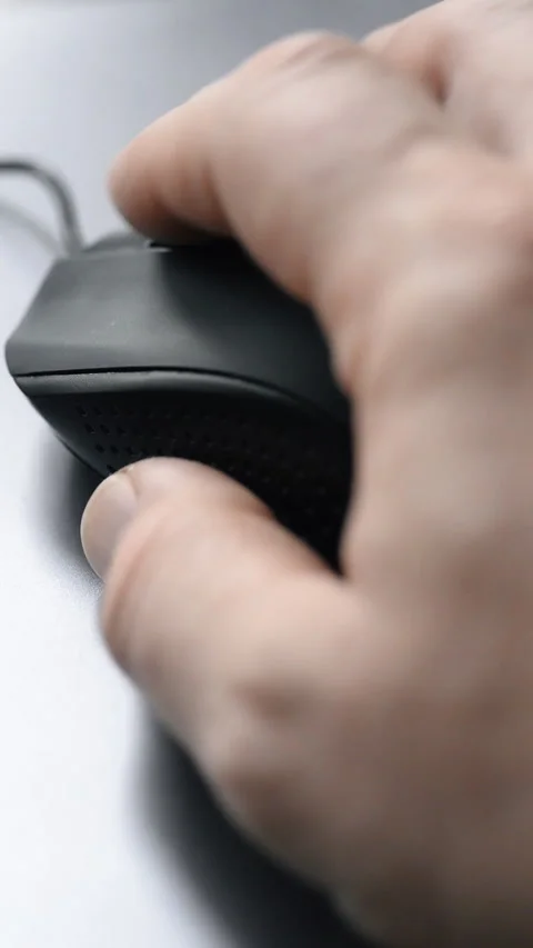 Hand holding a black computer mouse, close-up interaction Stock Footage 325705087