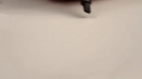 Hand holding a black marker draws on white paper Video stock 119889088