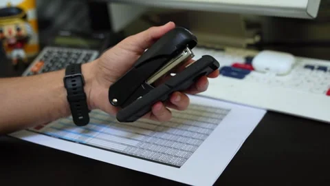 Hand Holding Black Stapler in Organized Office Scene Video stock 312374630
