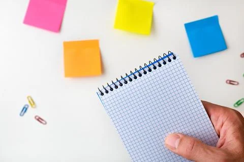 Hand Holding Blank Grid Notebook with Sticky Notes Stock Photos