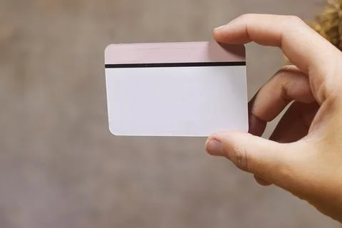 Hand Holding Blank Plastic Card With Magnetic Stripe for Mockup or ID and Busine Stock Photos