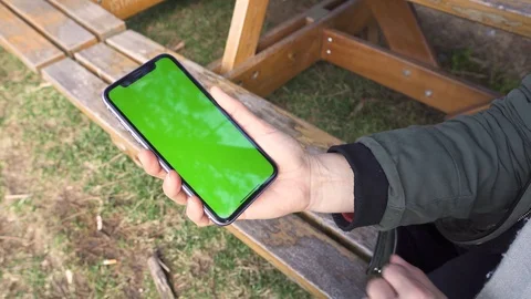 Hand Holding Blank Screen Phone with Blank Screen Outdoor Stock Footage 123972002