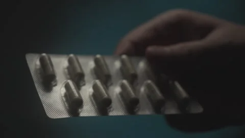 Hand Holding Blister Pack of Capsules Stock Footage 280551401