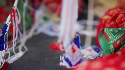Hand holding blue bead thread against red fabric background Stock-Footage 342399256