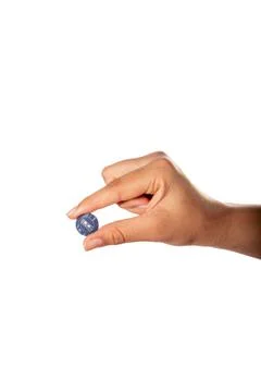 Hand holding blue clothes button. Isolated on white background. Stock Photos