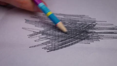 Hand Holding Blue Pencil Scribbling Dark Graphite Lines on White Paper Stock Footage 339365461