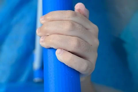 Hand holding a blue pool float Stock Photos