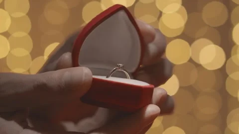 The hand holding the box with the wedding ring symbolizes the desire to create Stock Footage 242162494