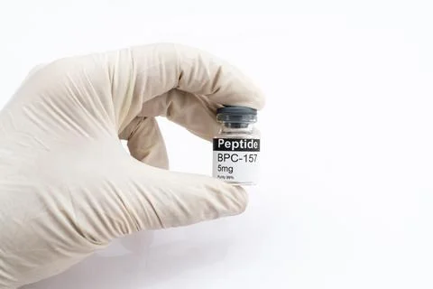 Hand holding BPC 157 peptide vial for research Stock Photos