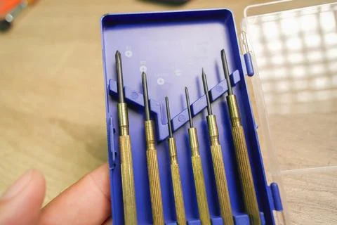 A hand holding brass precision screwdriver set Stock Photos